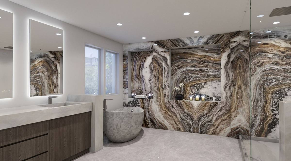Primary bath with book-matched stone feature wall, sculpted marble soaking tub, and backlit vanity mirrors